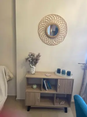a mirror on a wall above a wooden table at Seaside Argo apartment in Porto Rafti