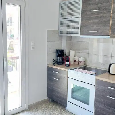 a kitchen with a stove and a white oven at Sunny apartment in Acropolis in Athens