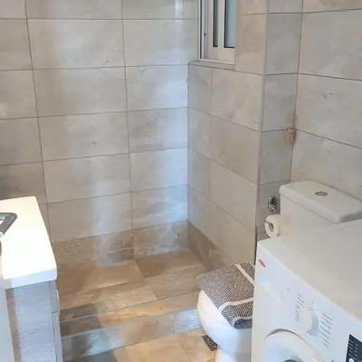 a bathroom with a toilet and a sink at Sunny apartment in Acropolis in Athens
