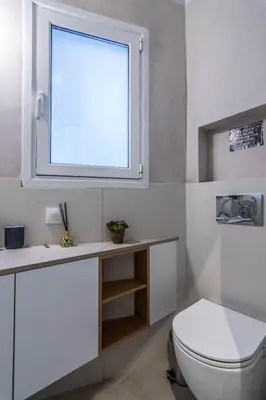 a bathroom with a white toilet and a window at ARIS Central Athens in Athens