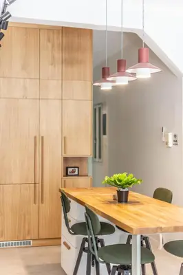 a kitchen with a wooden table and green chairs at ARIS Central Athens in Athens