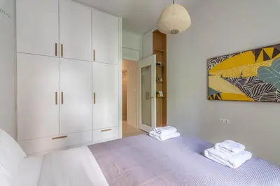 a bedroom with white cabinets and a purple bed at ARIS Central Athens in Athens