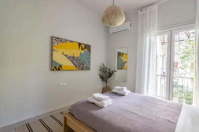 a bedroom with a bed with two towels on it at ARIS Central Athens in Athens
