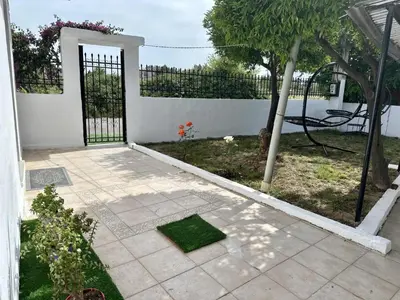a garden with a gate and a yard with a plant at Only Sun in Papangeláki