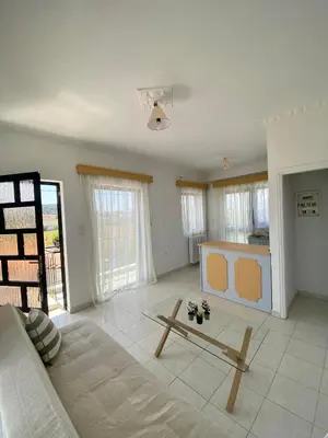 a living room with a couch and a table at Only Sun in Papangeláki