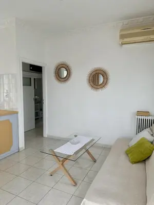 a living room with a couch and a glass table at Only Sun in Papangeláki