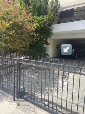 a gate with a sign in front of a parking garage at Athena Cocooning Apartment in Piraeus