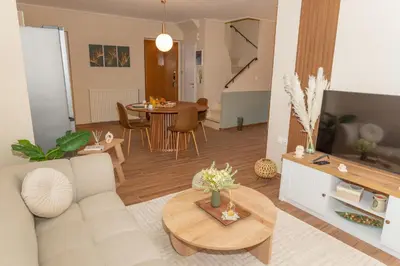 a living room with a couch and a table at Athena Cocooning Apartment in Piraeus