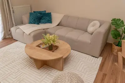 a living room with a couch and a coffee table at Athena Cocooning Apartment in Piraeus