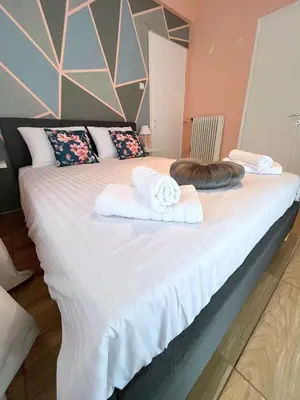 a bedroom with a large bed with towels on it at MediTerra Stay Athens Riviera in Athens