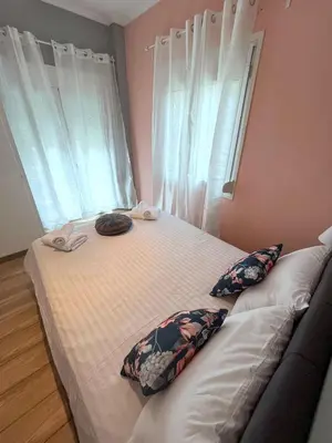 a bedroom with a large bed with two pillows at MediTerra Stay Athens Riviera in Athens