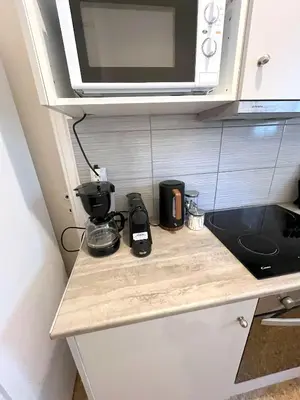 a kitchen counter with a coffee maker and a microwave at MediTerra Stay Athens Riviera in Athens