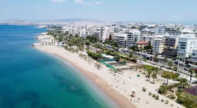 an aerial view of a beach with buildings and the ocean at MediTerra Stay Athens Riviera in Athens
