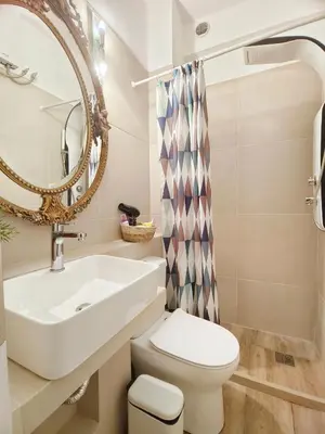 a bathroom with a sink and a toilet and a mirror at Athens Vibe in Historic Center in Athens