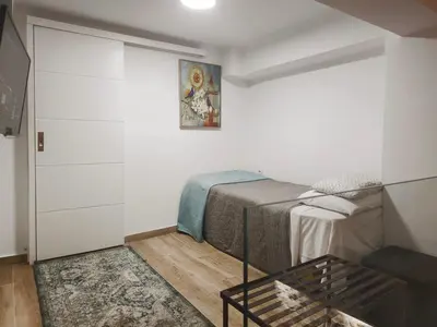a small bedroom with a bed and a table at Athens Vibe in Historic Center in Athens