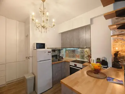 a kitchen with a white refrigerator and a chandelier at Athens Vibe in Historic Center in Athens