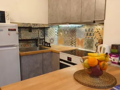 a kitchen with a bowl of fruit on a counter at Athens Vibe in Historic Center in Athens