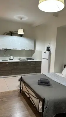a bedroom with a bed and a kitchen with a refrigerator at Apartment in Athens centre in Athens