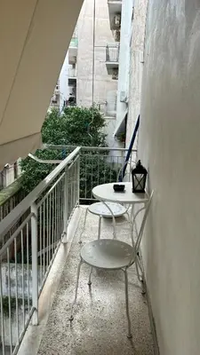 a table and a chair on a balcony at Apartment in Athens centre in Athens