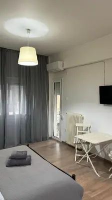 a bedroom with a bed and a table in it at Apartment in Athens centre in Athens