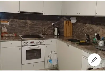 a kitchen with white cabinets and a stove top oven at Cozy Room with Sea View in Athens
