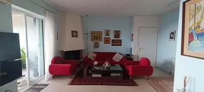 a living room with red couches and a tv at Cozy Room with Sea View in Athens