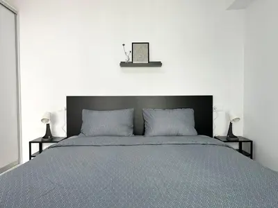 a bed with a black headboard and two lamps at Walk into Dream of Acropolis 10 in Athens
