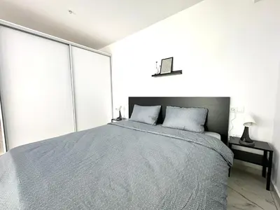 a bedroom with a bed with a blue comforter at Walk into Dream of Acropolis 10 in Athens