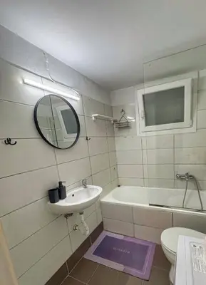 a bathroom with a sink and a toilet and a mirror at Apostolis Apartment, Argyroupoli, Athens in Athens
