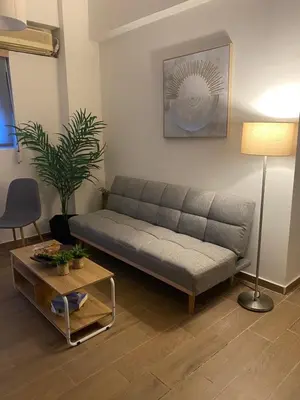 a living room with a couch and a table at Apostolis Apartment, Argyroupoli, Athens in Athens