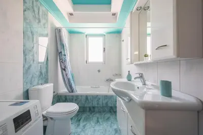 a bathroom with a toilet and a sink and a tub at Rigas apartment in Ilioupoli Athens in Athens