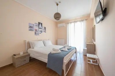 a bedroom with a bed and a television in it at Rigas apartment in Ilioupoli Athens in Athens