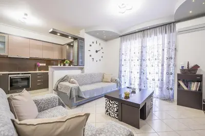 a living room with a couch and a table at Rigas apartment in Ilioupoli Athens in Athens