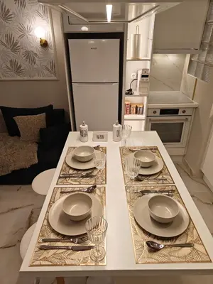 a kitchen with a table with plates and glasses on it at Lindy S in Athens