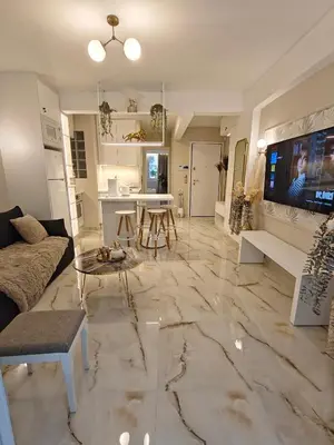 a living room with a couch and a table at Lindy S in Athens