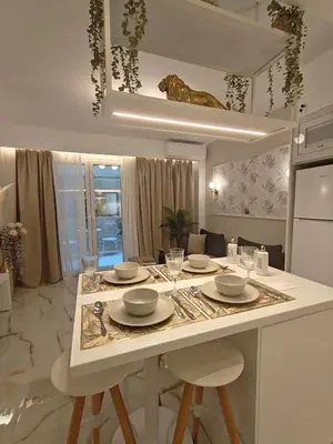 a kitchen with a table with plates and wine glasses at Lindy S in Athens
