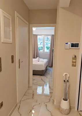 a bedroom with a bed and a hallway with marble floors at Lindy S in Athens