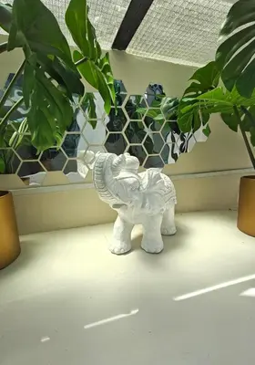 a white statue of an elephant next to some plants at Lindy S in Athens