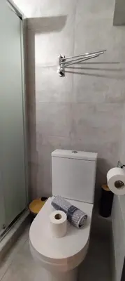 a bathroom with a toilet and two rolls of toilet paper at Studio Stratos ideal for 2-3 night Weekends in Athens
