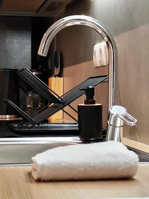 a sink with a faucet and a towel on a counter at Studio Stratos ideal for 2-3 night Weekends in Athens