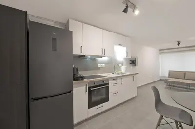a kitchen with a refrigerator and a table in it at Studio Stratos ideal for 2-3 night Weekends in Athens