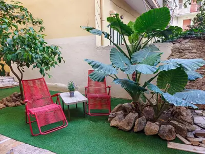 three chairs and a table and a plant at Zen Garden, 600m from Acropolis Museum in Athens