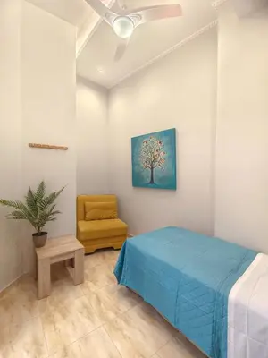 a bedroom with a blue bed and a chair at Zen Garden, 600m from Acropolis Museum in Athens