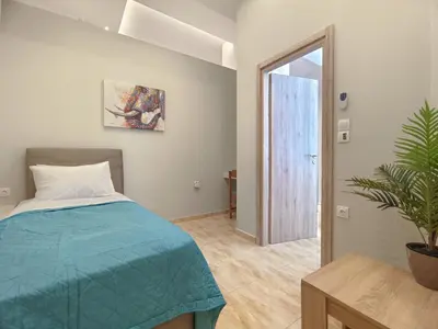 a bedroom with a bed and a potted plant at Zen Garden, 600m from Acropolis Museum in Athens