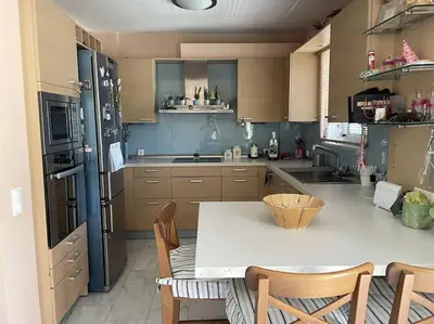 a large kitchen with a table and chairs in it at Lovely Maisonette & Parking in Athens
