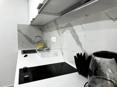 a kitchen with a counter top with a sink and a counter sidx sidx at Cozy Elegant Apartment #2 VIPGreece in Athens