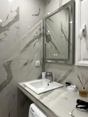 a white bathroom with a sink and a mirror at Cozy Elegant Apartment #2 VIPGreece in Athens
