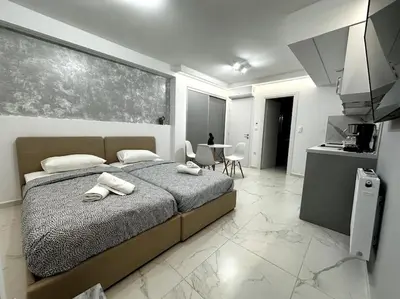 a bedroom with a bed with two towels on it at Cozy Elegant Apartment #2 VIPGreece in Athens