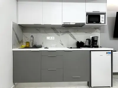 a white kitchen with white cabinets and a refrigerator at Cozy Elegant Apartment #2 VIPGreece in Athens