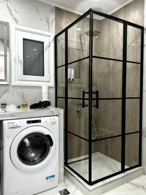 a bathroom with a washing machine and a tv at Cozy Elegant Apartment #2 VIPGreece in Athens